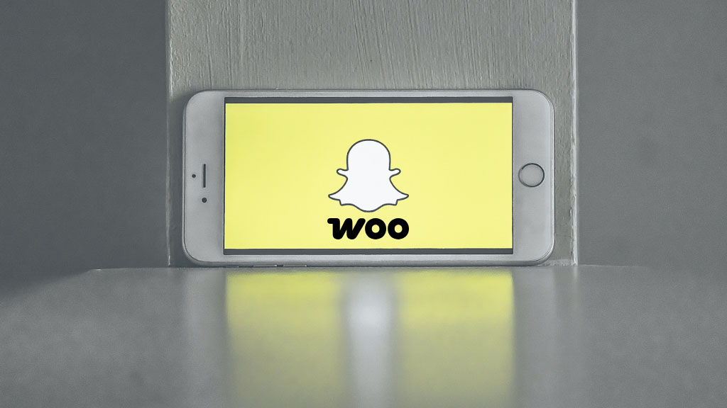Snapchat and WooCommerce logos on a mobile phone